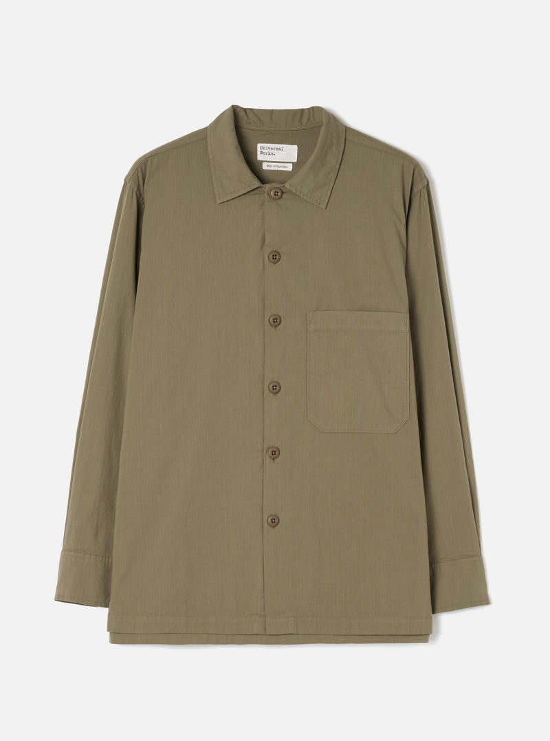 Front view of the Olive Slub Shirting Fatigue Shirt displayed against a clean off-white background. The shot details the dual chest pockets, front button placket, folded collar, and olive green slub cotton construction.
