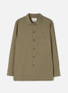 Front view of the Olive Slub Shirting Fatigue Shirt displayed against a clean off-white background. The shot details the dual chest pockets, front button placket, folded collar, and olive green slub cotton construction.