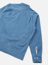 Back view of the Washed Indigo Recycled Herringbone Patch Lucky Shirt against a plain off-white background. The image showcases the clean back panel, shoulder seams, and relaxed hem cut of the washed indigo shirt.