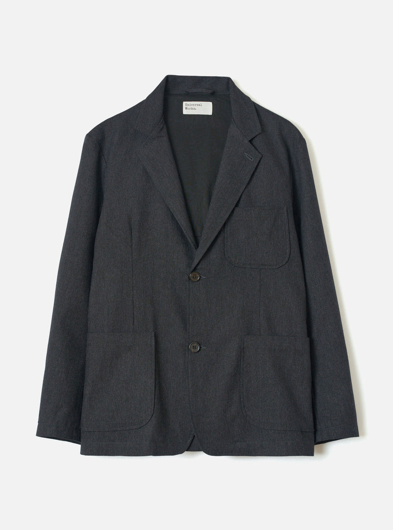 Front view of the Charcoal Recycled Italian Tweed Two Button Jacket displayed against a plain white backdrop. The image highlights the notch lapels, front button closure, chest patch pocket, and dark heathered tweed finish.