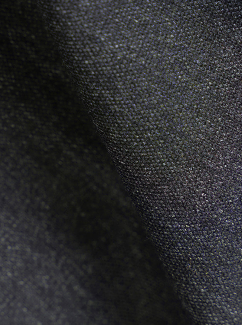 A close-up fabric swatch view showing the textured weave and multi-tonal flecks of the Charcoal Recycled Italian Tweed Two Button Jacket. The detailed macro shot highlights the quality of the recycled wool blend fabric.