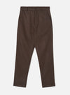 A full-length front view of a model wearing the Brown Recycled Italian Tweed Military Chino in a clean studio setting. The image showcases the trousers' straight, slim fit, front waist details, and textured brown tweed fabric.