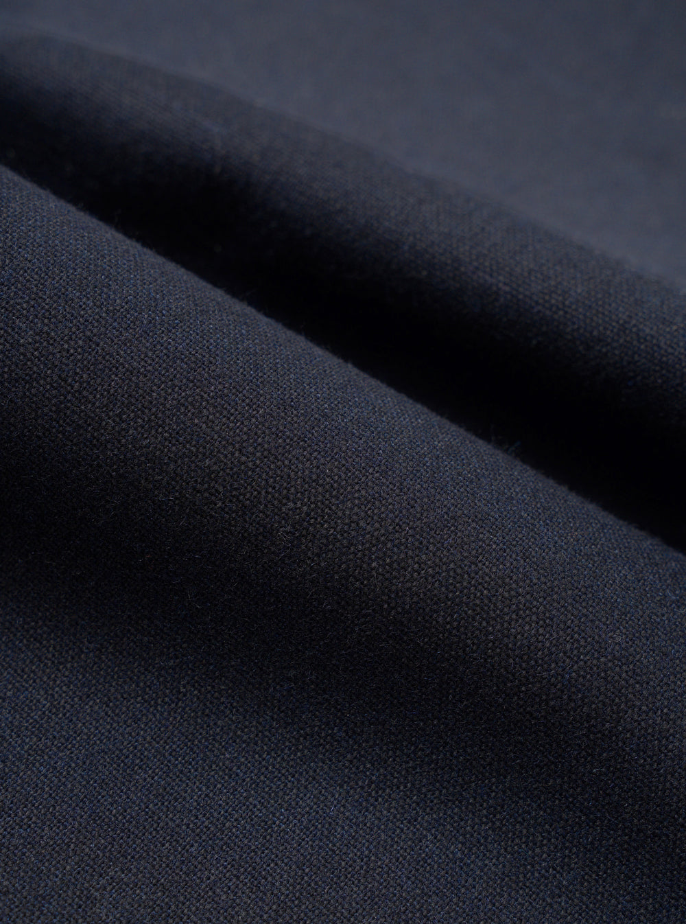 A close-up fabric swatch image showing the intricate texture of the Navy Recycled Italian Tweed Military Chino against a plain white background, highlighting the rich navy blue recycled wool blend yarns.