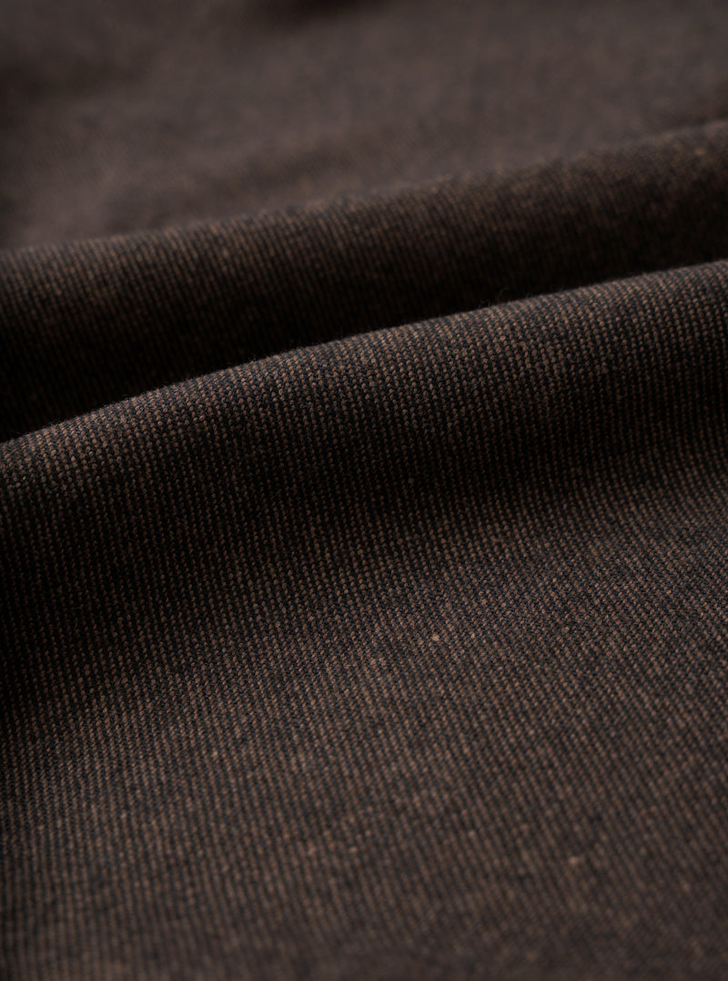 A close-up fabric swatch image showing the rich texture of the Brown Recycled Italian Tweed Pleated Track Pant on a white background, highlighting the brown recycled wool yarn weave.