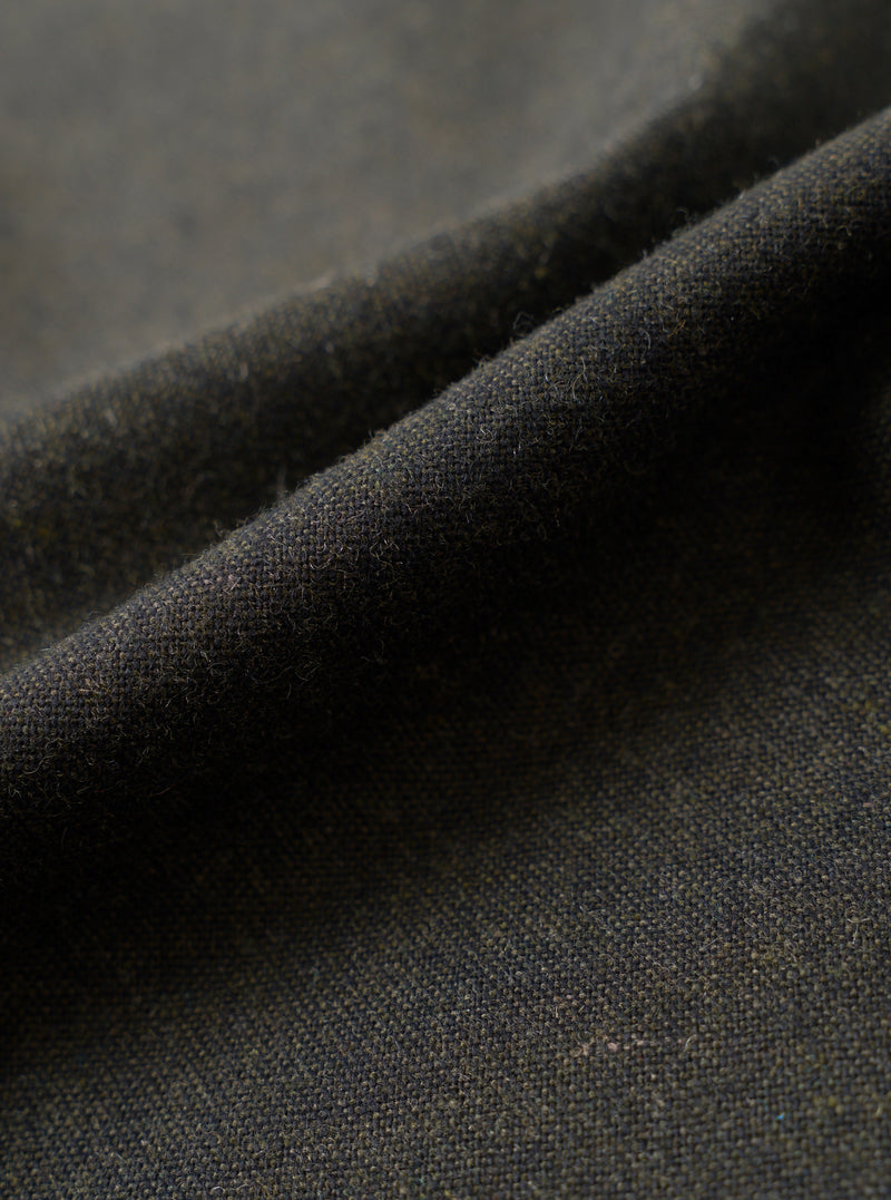 A close-up fabric swatch image displaying the detailed texture of the Olive Recycled Italian Tweed Pleated Track Pant on a plain white background, showing the intricate weave of recycled wool blend fibers.