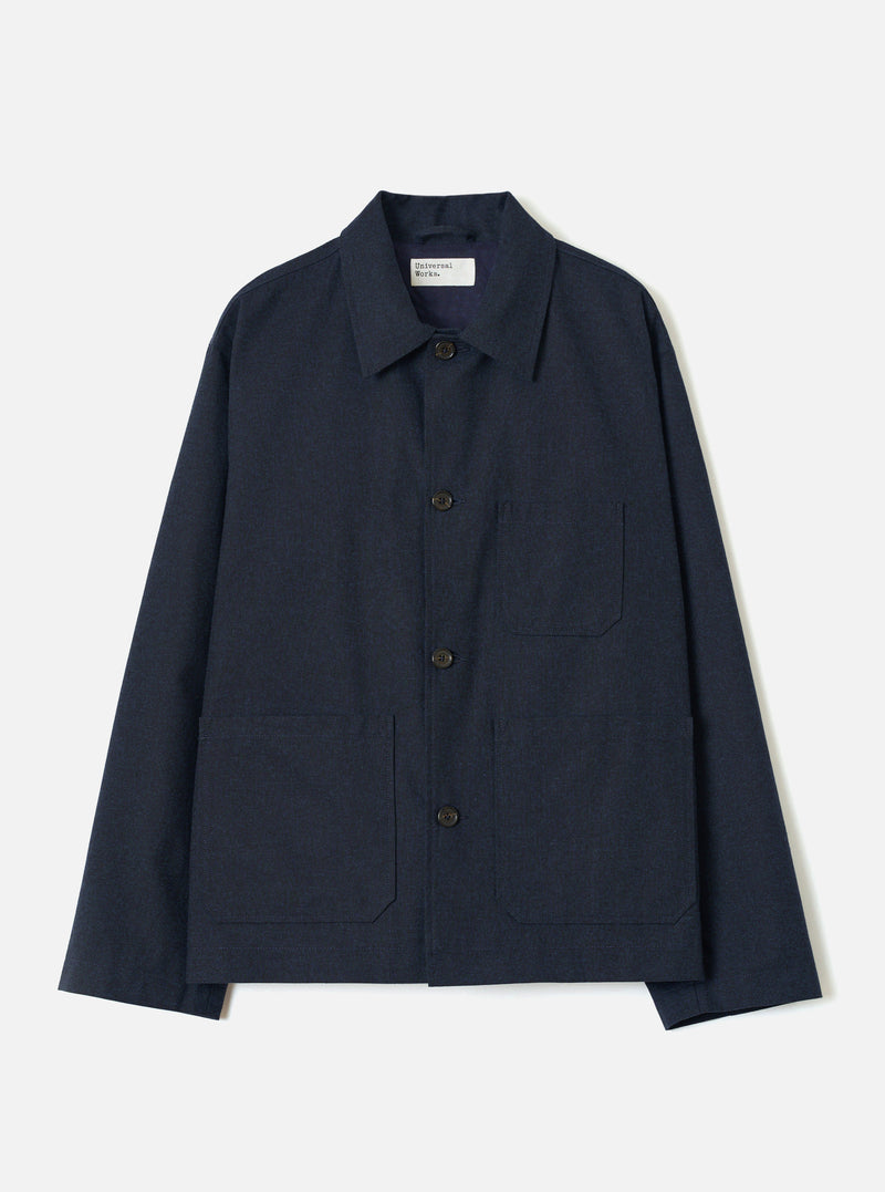 A front view of a model wearing the Navy Lucca Suiting Ives Jacket against a neutral studio backdrop. The photograph showcases the jacket's relaxed fit, button front closure, collar, and classic patch pockets in navy blue.