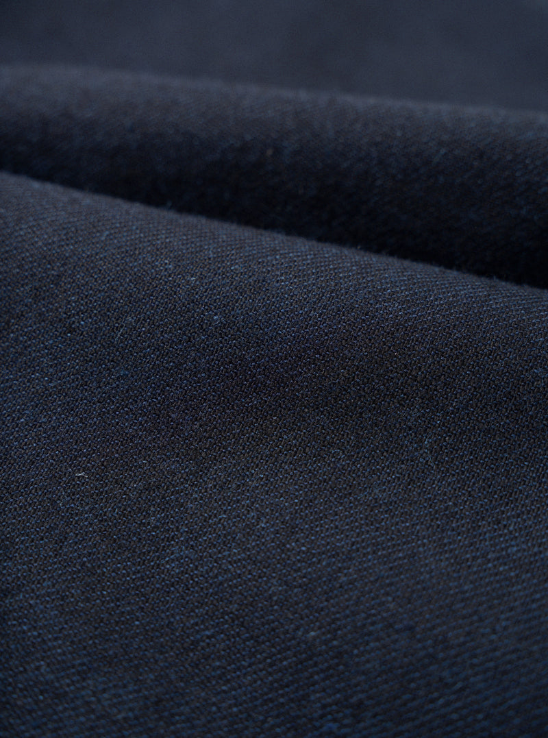 A close-up fabric swatch image of the Navy Lucca Suiting Military Chino isolated on a plain white background, showing the fine weave structure and surface texture of the navy blue cotton-blend fabric.