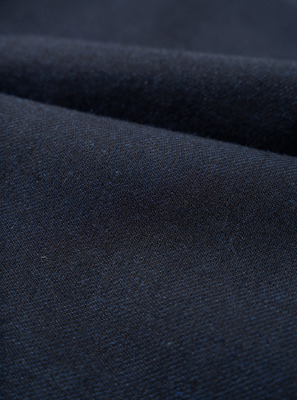 A close-up fabric swatch image of the Navy Lucca Suiting Military Chino isolated on a plain white background, showing the fine weave structure and surface texture of the navy blue cotton-blend fabric.