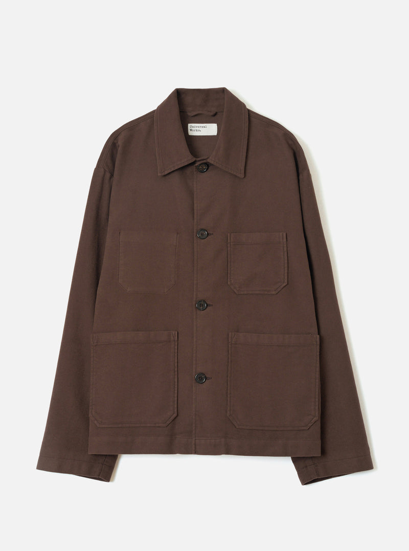 A front view of a model wearing the Brown Comfort Moleskin Ives Jacket against a neutral studio background, illustrating the casual chore jacket cut, front button placket, and rich brown moleskin texture.