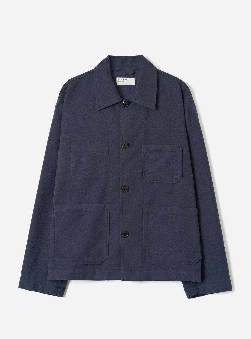 A full-length front view of a model wearing the Navy Comfort Moleskin Ives Jacket against a neutral studio backdrop, showcasing the button front, utility patch pockets, and rich navy blue moleskin fabric.