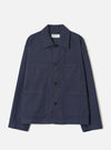 A full-length front view of a model wearing the Navy Comfort Moleskin Ives Jacket against a neutral studio backdrop, showcasing the button front, utility patch pockets, and rich navy blue moleskin fabric.