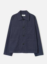 A full-length front view of a model wearing the Navy Comfort Moleskin Ives Jacket against a neutral studio backdrop, showcasing the button front, utility patch pockets, and rich navy blue moleskin fabric.