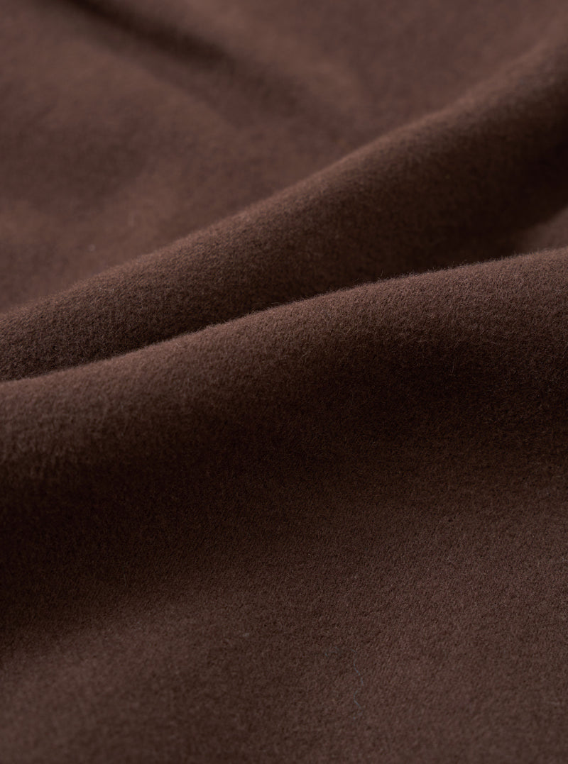 A close-up fabric swatch image of the Brown Comfort Moleskin Pleated Track Pant against a white background, demonstrating the dense weave and soft brushed tactile surface of the rich brown cotton moleskin material.