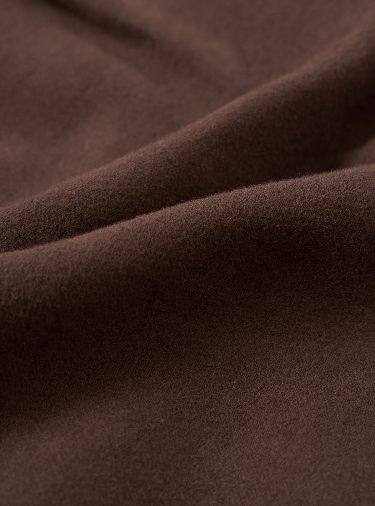 A close-up fabric swatch image of the Brown Comfort Moleskin Pleated Track Pant against a white background, demonstrating the dense weave and soft brushed tactile surface of the rich brown cotton moleskin material.