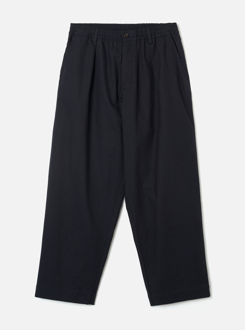 Front view of the Navy Lucca Suiting Oxford Pant displayed on a plain white background, featuring a wide loose leg, single front pleat, elasticated drawstring waistband, and deep navy cotton suiting material.