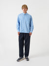 A full-length studio photograph of a model wearing the Navy Lucca Suiting Oxford Pant against a neutral backdrop, showcasing the relaxed wide leg silhouette, single front pleat, and dark navy suiting drape.