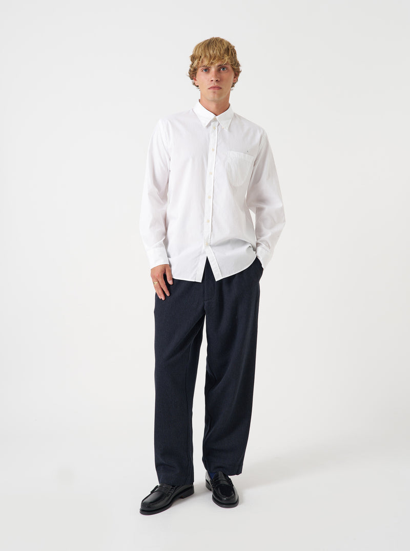 A full-length studio shot of a model wearing the Navy Airline Flannel Oxford Pant against a neutral backdrop, highlighting the wide loose leg cut, soft wool-flannel drape, and navy colorway.