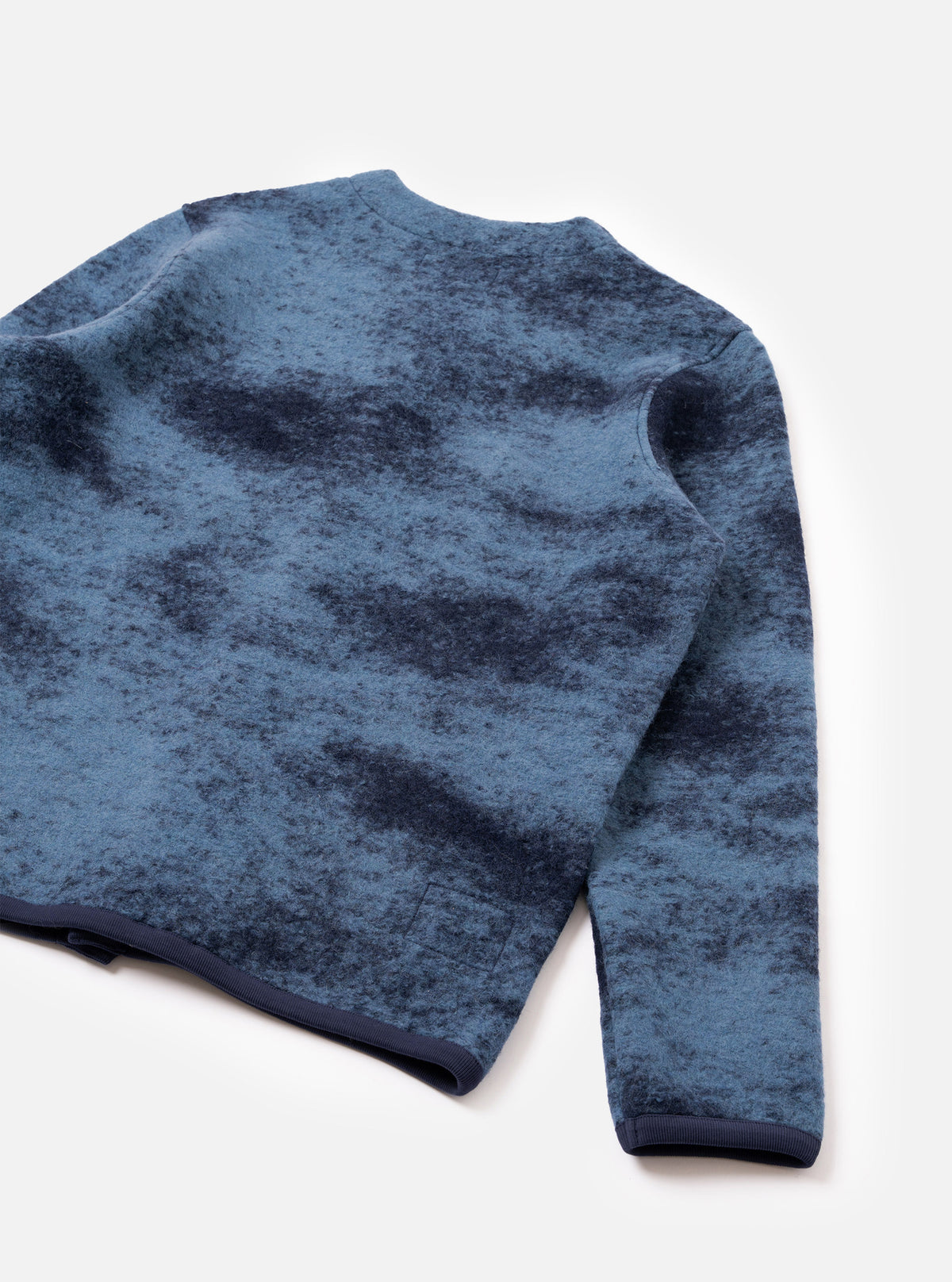 A back view of a model wearing the Blue Cloud Camo Knit Cardigan against a plain background, highlighting the full rear panel, blue cloud camouflage pattern, ribbed hem, and relaxed fit of the knitted garment.