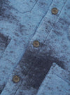 A close-up shot of a model wearing the Blue Cloud Camo Knit Cardigan, focusing on the button placket, neck collar, front patch pockets, and detailed cloud camo pattern in shades of blue knit wool fabric.