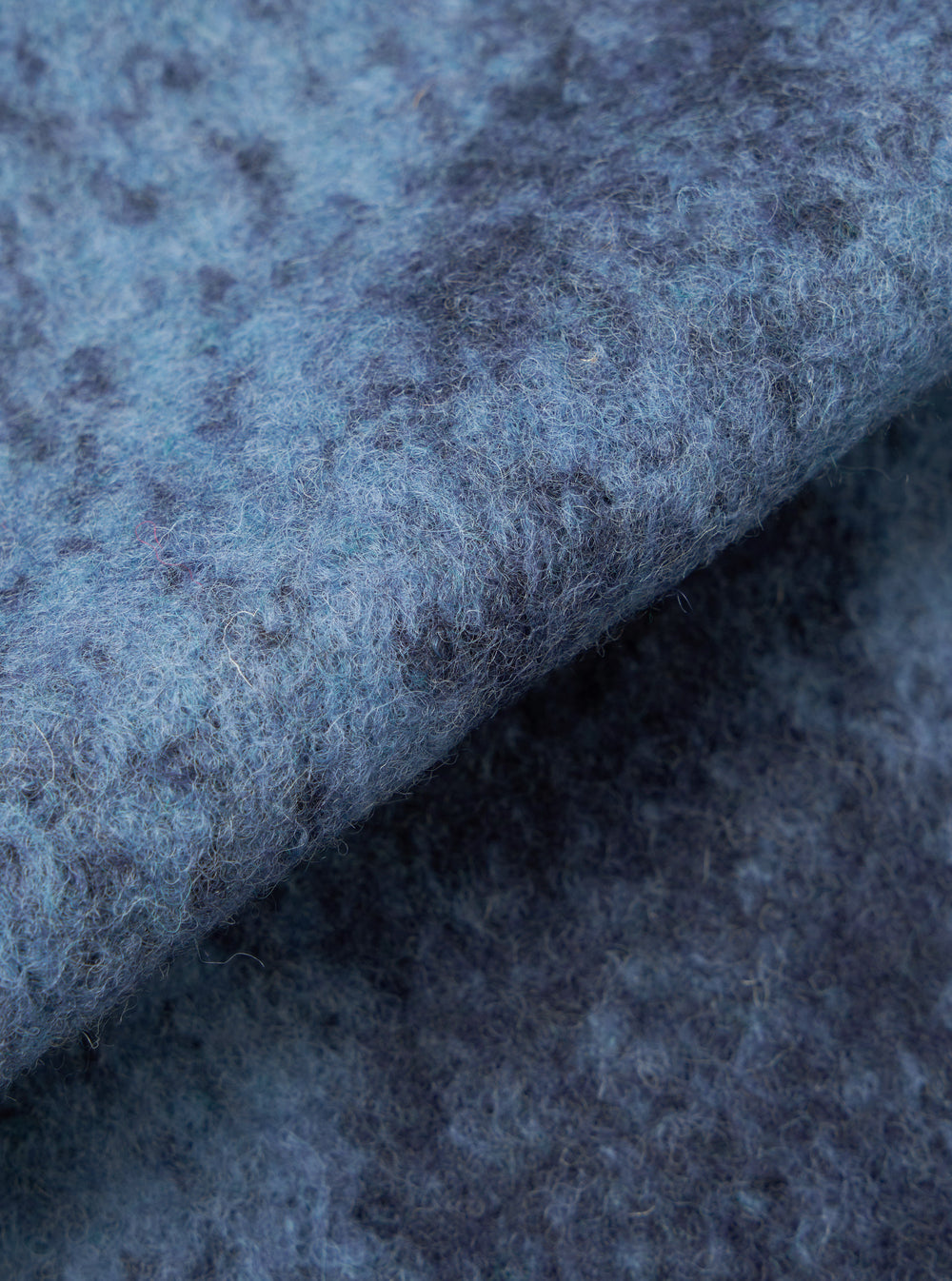 A close-up fabric swatch image showing the detailed blue cloud camouflage knit pattern of the Blue Cloud Camo Knit Cardigan against a white background, highlighting the soft texture of the wool yarn.