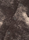 A close-up photograph of a model wearing the Brown Cloud Camo Knit Cardigan, highlighting the button placket, ribbed trim, front pocket, and soft textured wool fabric with brown cloud camo pattern.