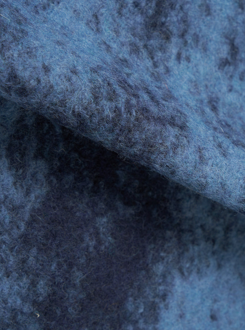 A fabric swatch image of the Blue Cloud Camo Knit Zip Gilet against a plain white background, providing a detailed view of the blue cloud camo knit pattern and soft wool fabric texture.