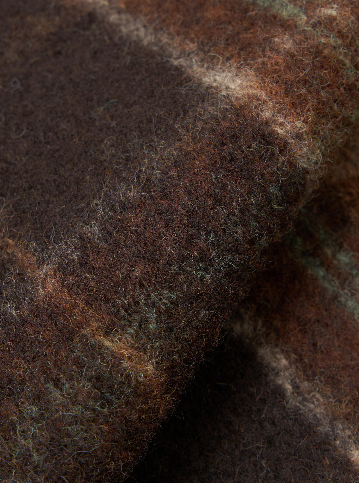 Close-up swatch image of the fabric used for the Brown Pino Wool Fleece Military Liner Jacket on a white background, highlighting the soft texture and fibers of the recycled wool-blend fleece.