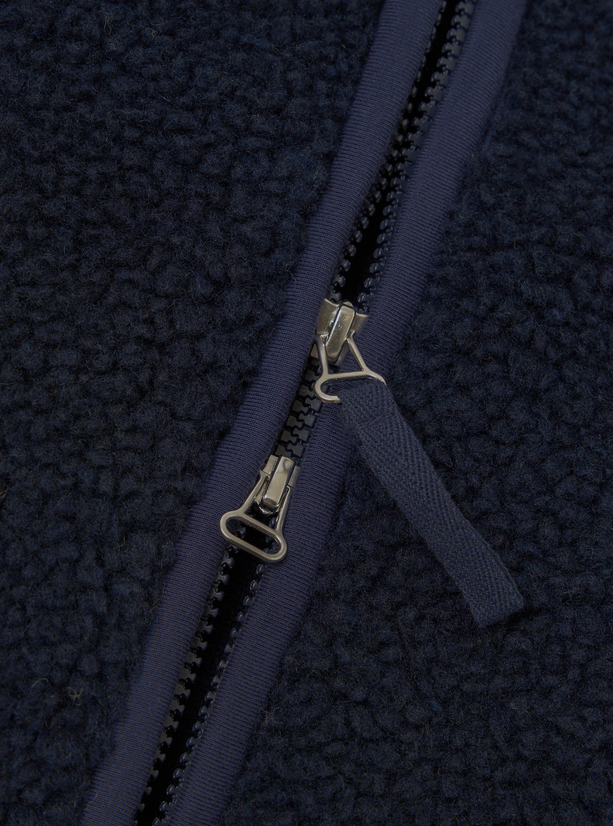 Detailed close-up image of the Navy Artic Fleece Hep Mountain Jacket on a white background, emphasizing the front zipper hardware, fleece texture, chest pocket detail, and collar stitching.