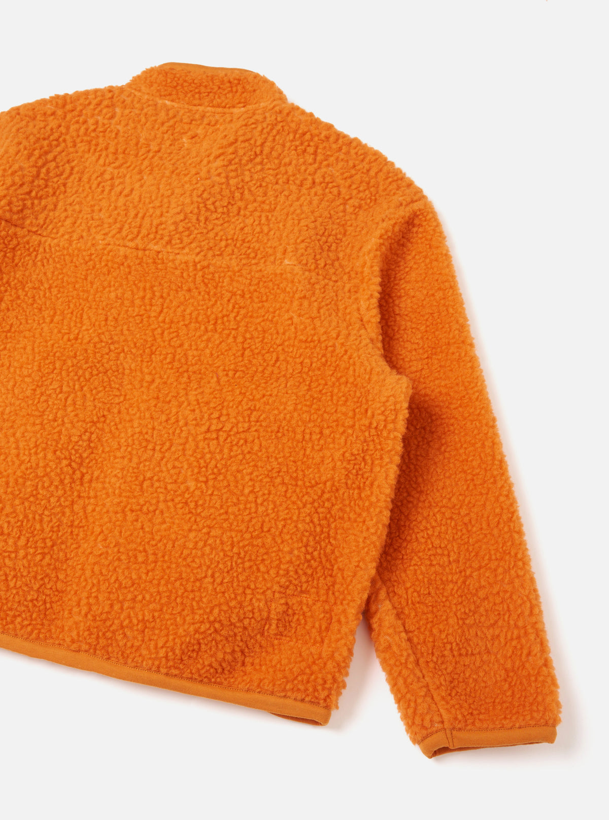 Back view of the Orange Artic Fleece Hep Mountain Jacket set against a clean white backdrop, detailing the seamless shoulder construction, soft fleece texture, and bright orange finish.