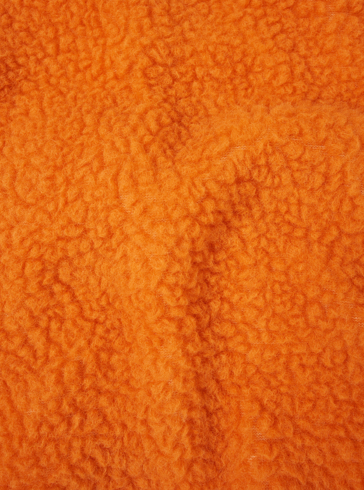 Detailed fabric swatch image showcasing the bright orange wool-blend texture of the Orange Artic Fleece Hep Mountain Jacket on a neutral white background, showing the soft pile of the fleece.