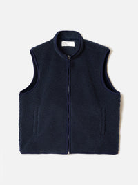 A full-length front view of a model wearing the Navy Artic Fleece Hep Mountain Gilet in a bright studio setting. The image showcases the sleeveless design, front zip closure, side pockets, and deep navy wool-blend fleece.
