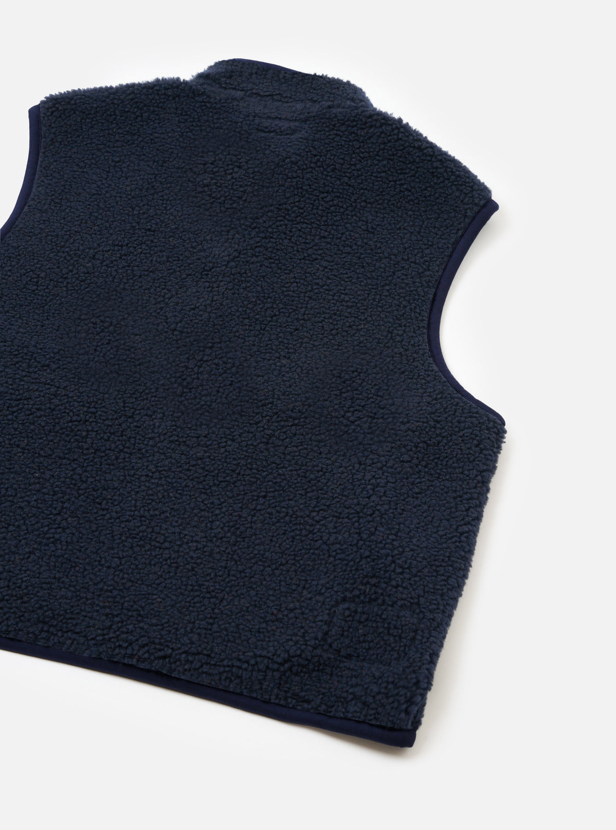 A back view of a model wearing the Navy Artic Fleece Hep Mountain Gilet against a plain studio background. The shot highlights the clean back panel construction, comfortable fit, and dark navy fleece texture.