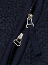 A close-up detail shot of a model wearing the Navy Artic Fleece Hep Mountain Gilet, highlighting the chest area, zip pull, collar trim, and tactile navy fleece fabric against a neutral studio backdrop.