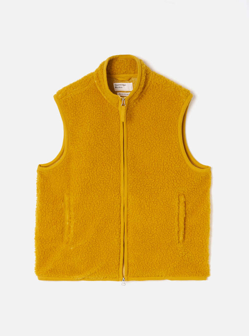 A full-length front view of a model wearing the Yellow Artic Fleece Hep Mountain Gilet in a plain studio setting. The image emphasizes the sleeveless silhouette, zip-front closure, and vibrant yellow fleece fabric.