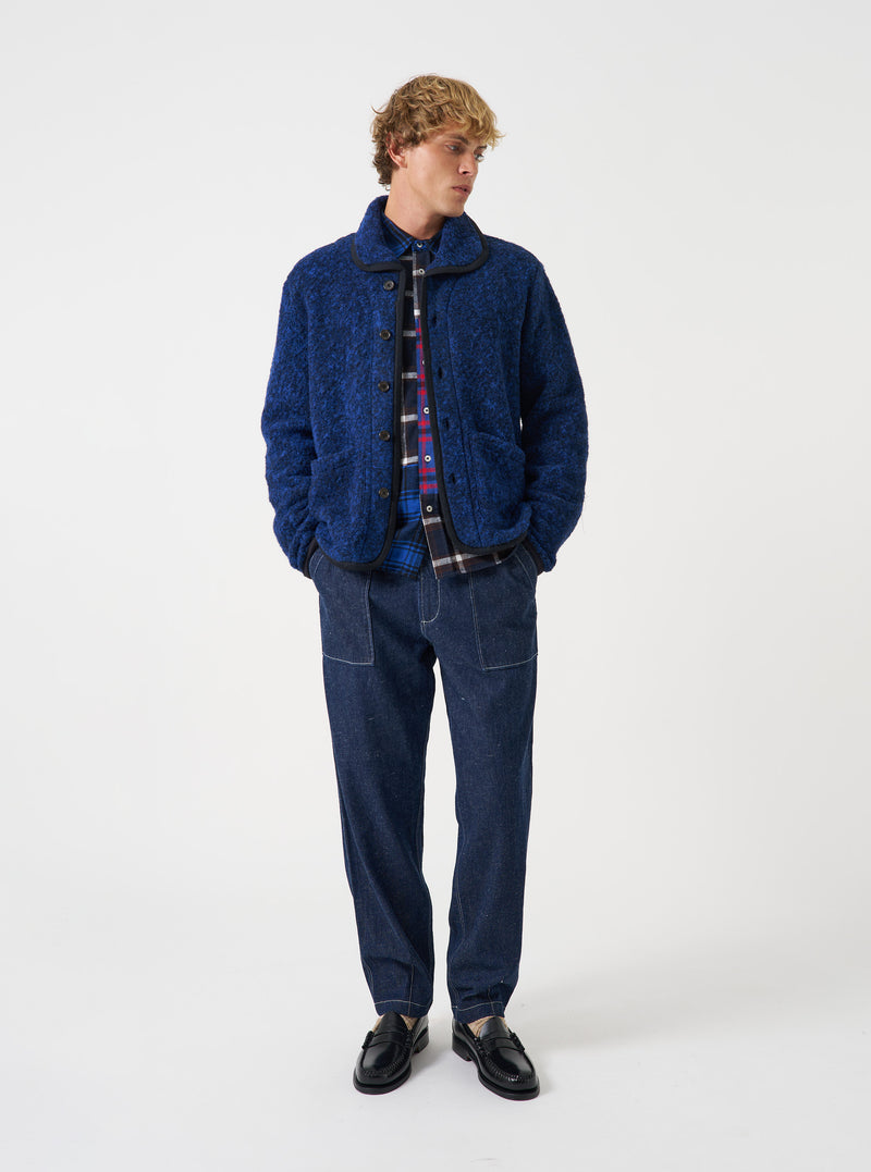 Front view of a model wearing the Blue Bouclet Fleece Lancaster Jacket against a plain neutral studio background. The shot highlights the textured blue fleece fabric, button-front closure, collar, and front patch pockets.