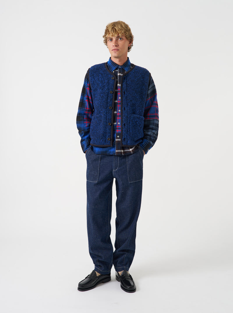 Front full-length view of a model wearing the Blue Bouclet Fleece Lancaster Gilet over a shirt against a neutral background. The image highlights the sleeveless design, buttoned front, and cozy textured fleece fabric.