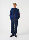 Front full-length view of a model wearing the Blue Bouclet Fleece Lancaster Gilet over a shirt against a neutral background. The image highlights the sleeveless design, buttoned front, and cozy textured fleece fabric.
