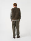 Back view of a model wearing the Brown Bouclet Fleece Lancaster Gilet against a minimal light background. The photograph highlights the overall fit, straight hem, and distinct textured finish of the brown fleece fabric.