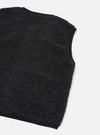 Charcoal boucle style fleece gilet laid flat on a white studio surface, shot at an angle showing the back and one armhole. The textured, looped fleece body is charcoal grey with contrast black binding along the armhole edge, neckline and hem.