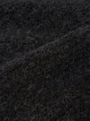 Close-up detail shot of the charcoal boucle style fleece fabric used in the Lancaster Gilet. The curly, looped texture of the boucle style fabric is clearly visible, showing tightly coiled fibres in a dark charcoal grey tone with subtle variations in depth across the surface.