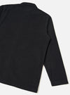 Rear studio view of the Black Fine Cord Bakers Overshirt against a clean white backdrop. The photo highlights the flat back yoke, straight hemline, and fine-ribbed black corduroy fabric construction.