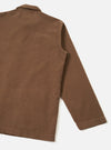 Back product photograph of the Brown Fine Cord Bakers Overshirt on a seamless white backdrop, showcasing the clean rear yoke, straight hem finish, and fine-ribbed texture of the warm brown corduroy material.