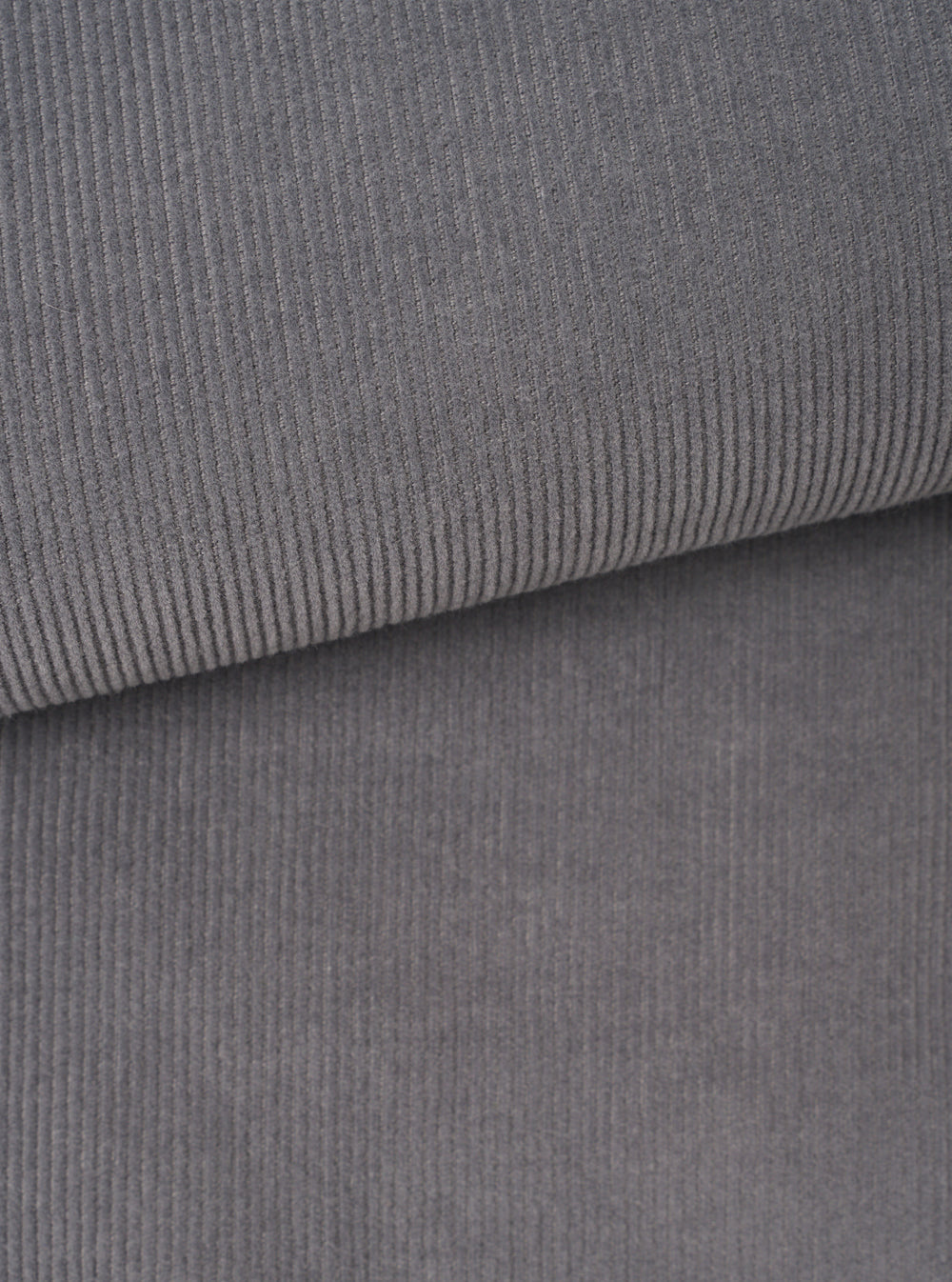 A detailed close-up fabric swatch of the Universal Works Grey Fine Cord Bakers Overshirt, displaying the fine-wale cotton corduroy texture and grey tone up close against a plain background.