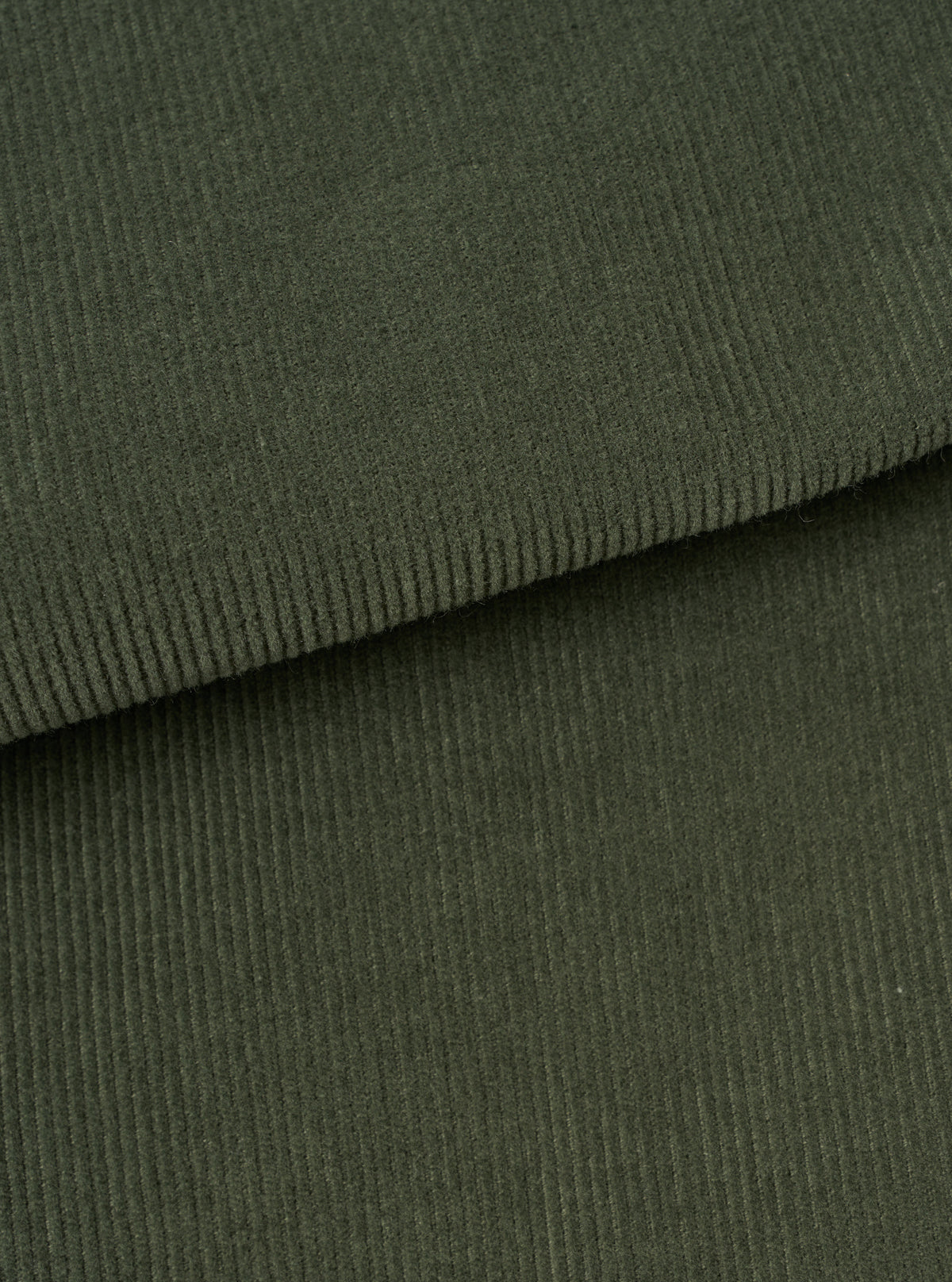 An extreme close-up fabric swatch of the Universal Works Olive Fine Cord Bakers Overshirt, displaying the soft fine-wale olive green cotton corduroy texture in detail against a plain neutral background.