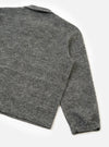 Back view of a male model wearing the Universal Works Grey Marl Wool Mix Knit Rams Jacket against a plain background, displaying the relaxed fit, clean hem, and textured grey wool mix fabric.