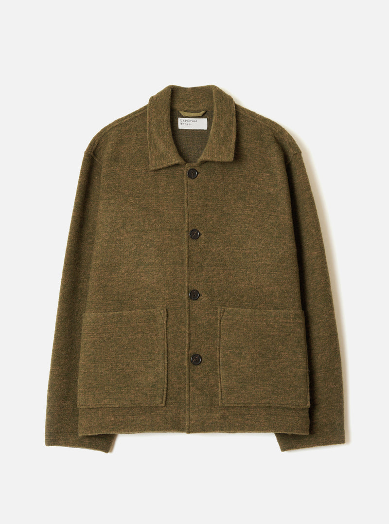 A full-length front view of a model wearing the Olive Wool Mix Knit Rams Jacket against a plain neutral studio background, showcasing the jacket's button front, olive green textured knit fabric, and front patch pockets.