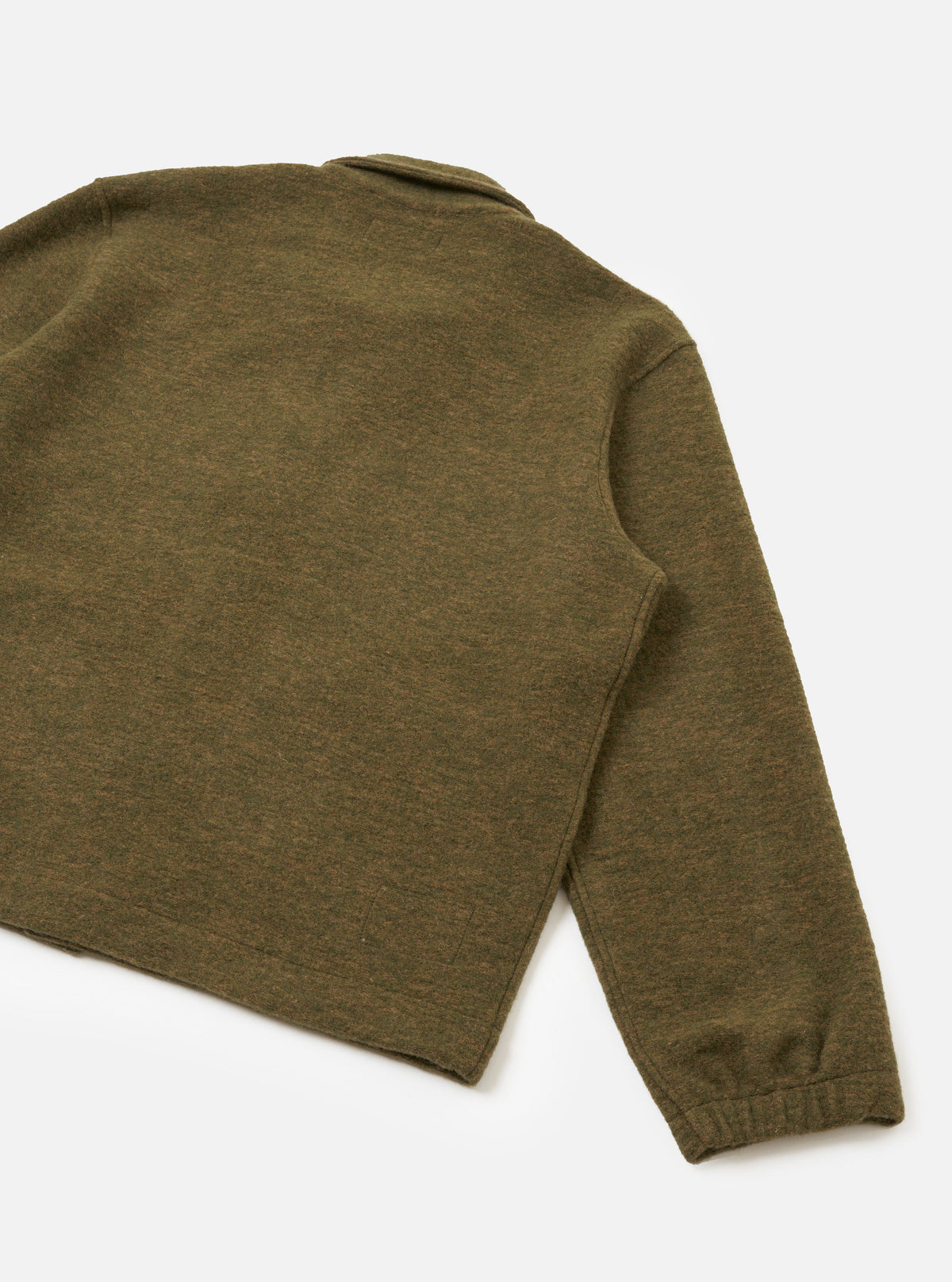A full-length back view of a model wearing the Olive Wool Mix Knit Rams Jacket in a clean studio setting, highlighting the back seam construction, relaxed fit, and cozy wool mix fleece texture in olive green.