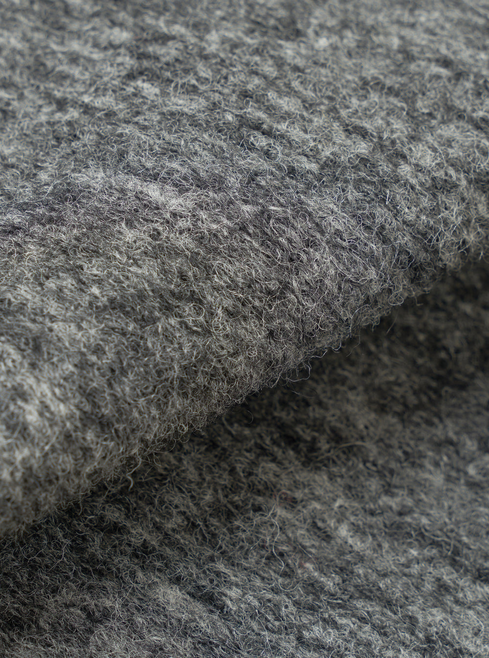 A close-up fabric swatch photograph of the Grey Marl Wool Mix Knit Advance Cardigan set against a white backdrop, displaying the intricate grey marl knit pattern and soft wool blend yarn texture.