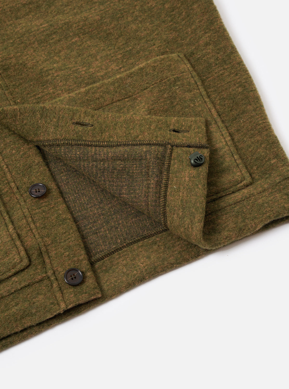 A detailed close-up shot of a model wearing the Olive Wool Mix Knit Advance Cardigan, highlighting the button fastening, V-neckline, and textured olive wool mixture fabric in a studio setting.