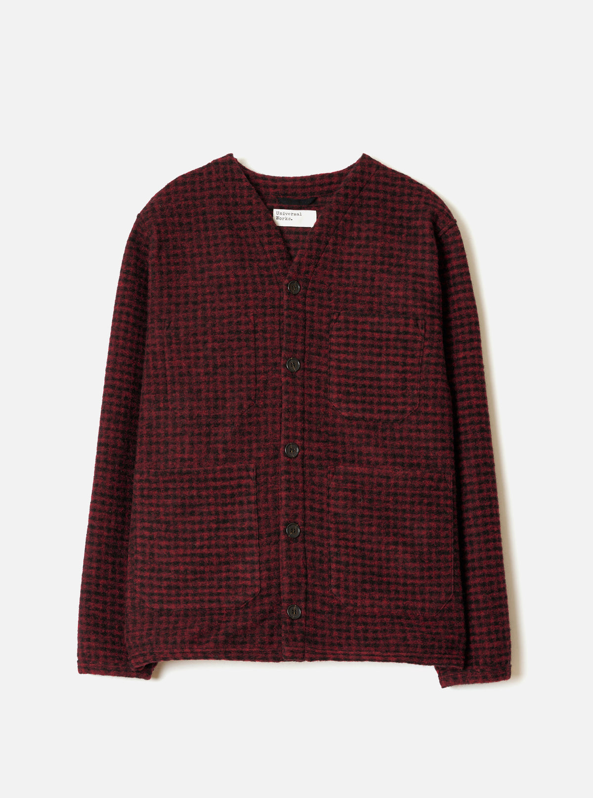 A full-length front view of a model wearing the Black/Red 533 Wool Mix Cardigan in a plain studio setting, showing the bold black and red patterned knit, front buttons, and comfortable V-neck style.